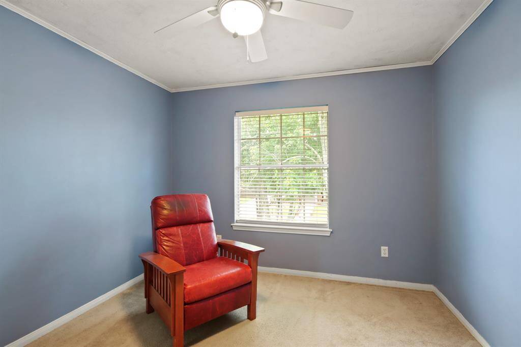 Cozy room with soft blue walls, features a large window that provides natural light and cozy area.