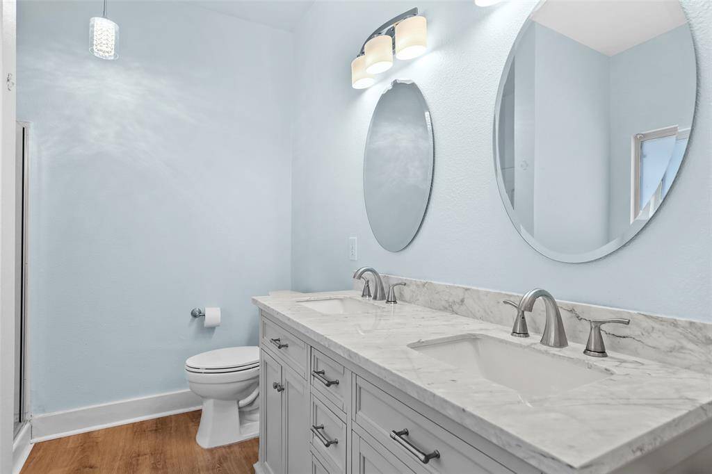Primary bath has large tub and separate shower.