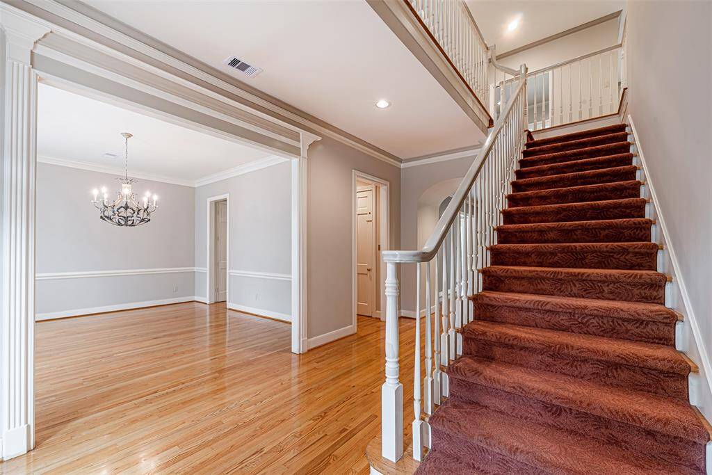 View from the front entry looking into the dining room with custom wood work and trim on entry way.