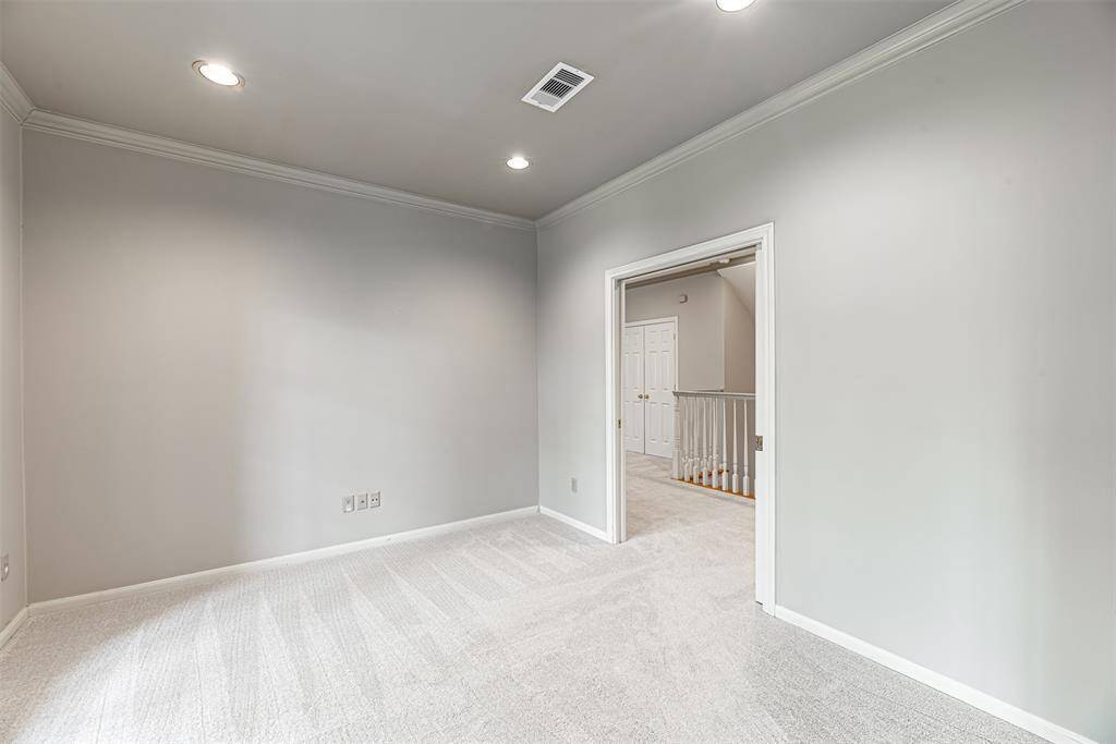 View from primary bedroom looking into flex room that can be used as nursery with pocket doors off the hallway.