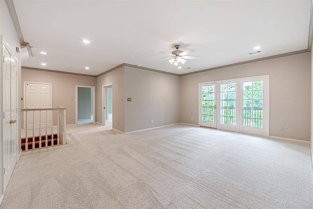 Enormous open gameroom with recent carpet and french doors leading to outside balcony with picturesque views!