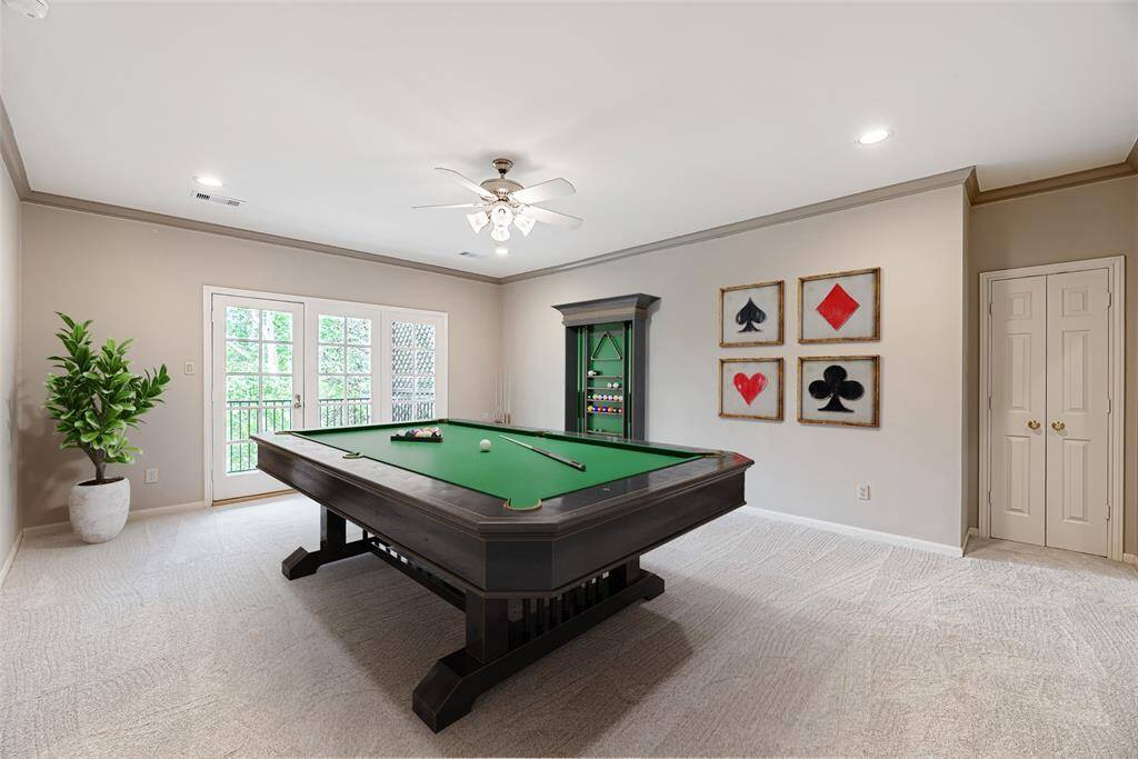 Another angle of the gameroom with storage closet and has ample lighting with canned lights and ceiling fan with lights. *Virtually staged photo*