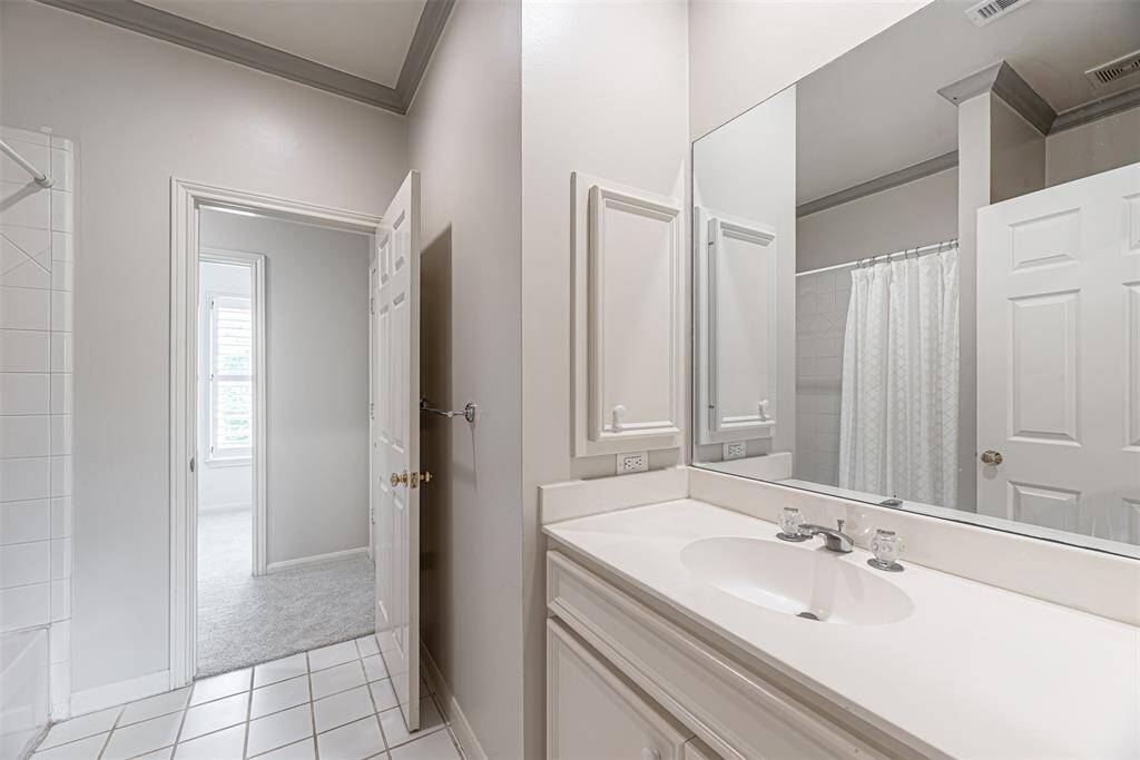 Tub/shower in en-suite bath off secondary bedroom.