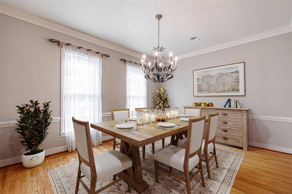 Dining room features hardwood flooring, crown molding and chair rail. *Virtually staged picture*
