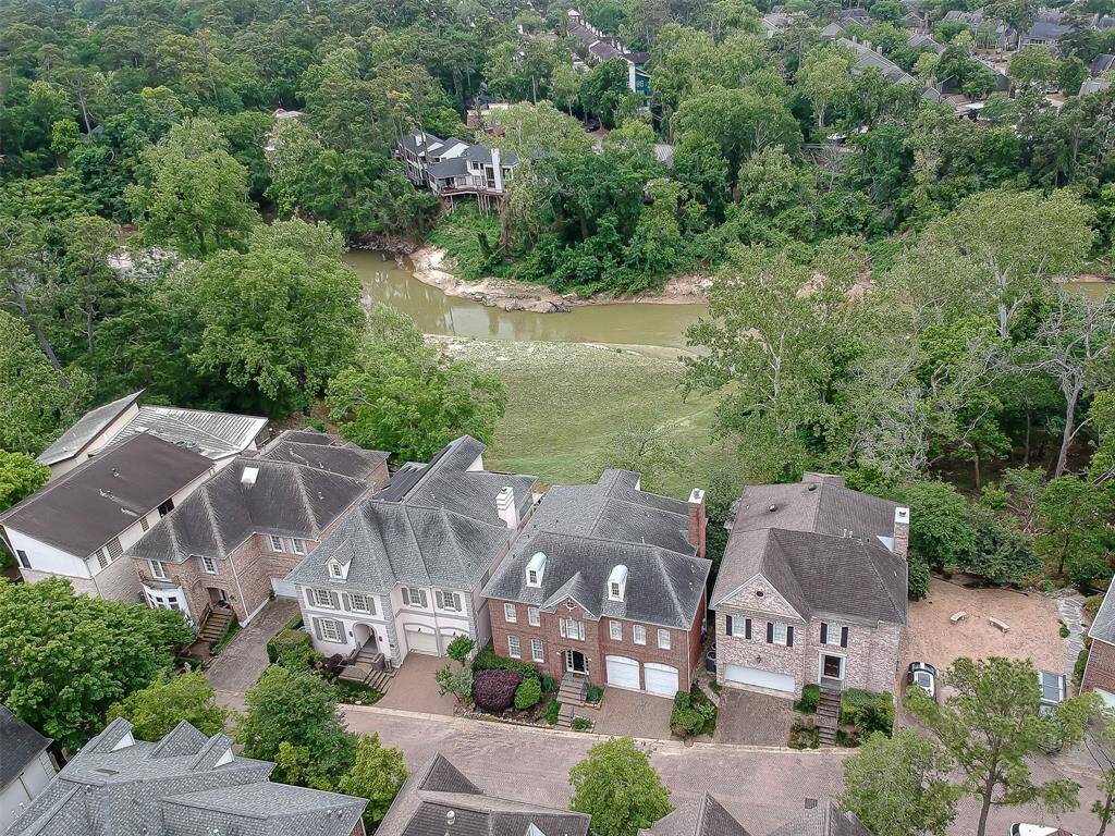 Manicured back yard down to the bayou with rock landscape.