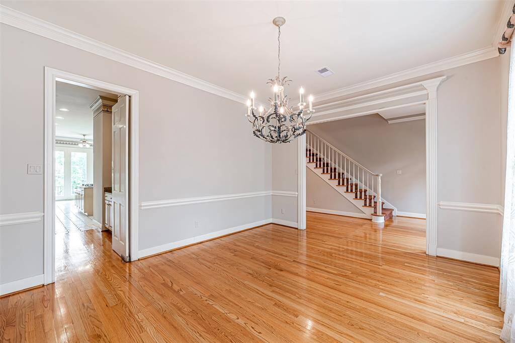 The dining room has access to the kitchen and a custom ornate chandelier.