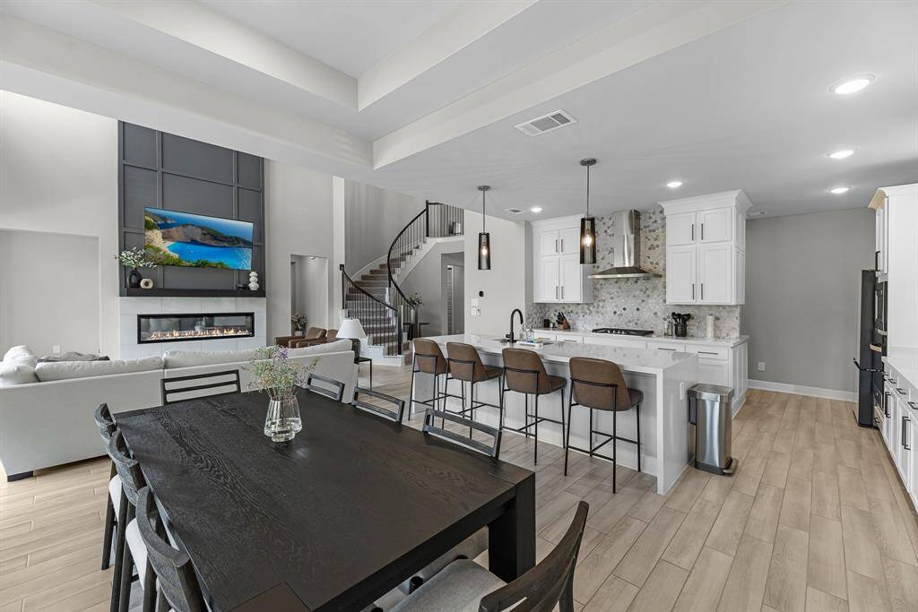 View of the dining area showing the seamless transition between the kitchen and open living room.