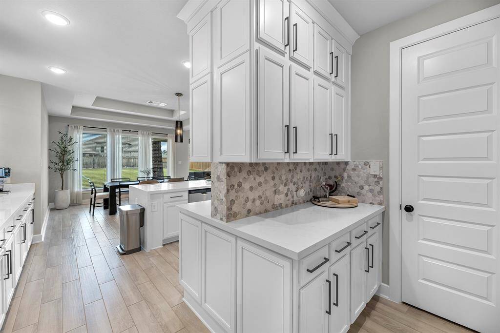 WOW! Behind the kitchen is a useful prep kitchen. Perfect for storage or a custom coffee bar! Endless possibilities.