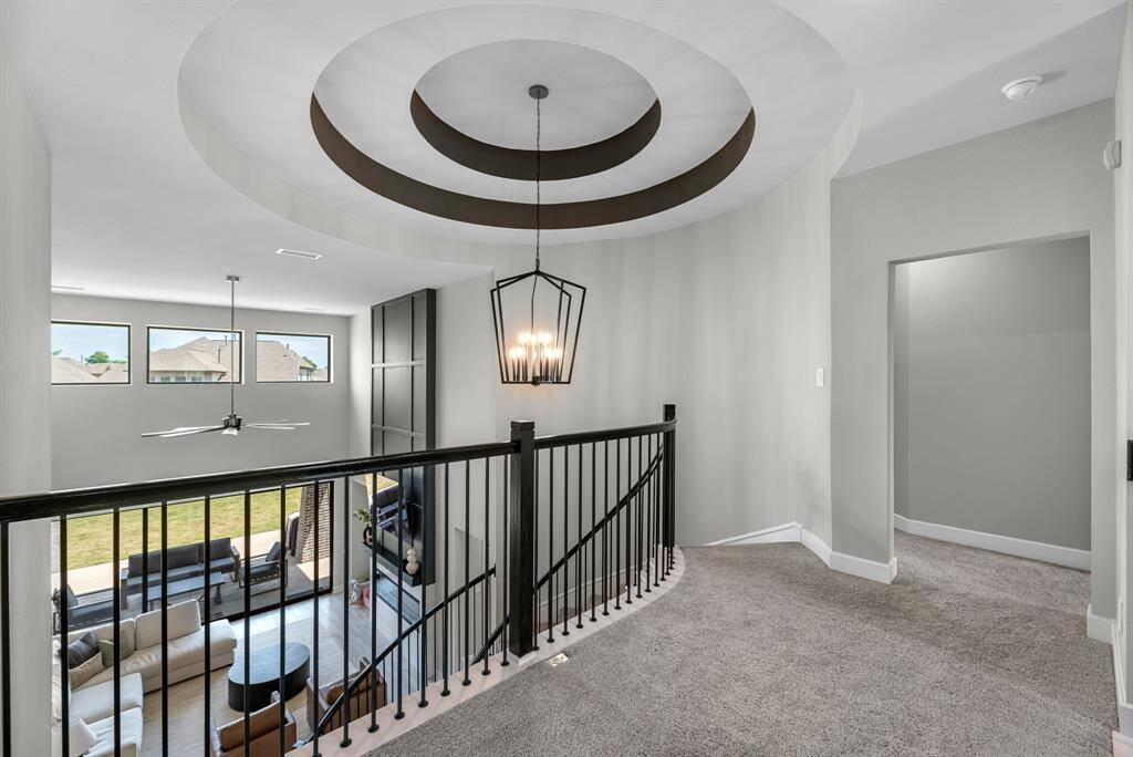 Soaring ceilings and tray details impress on your walk upstairs.