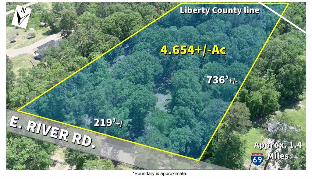 Stunning aerial view of 4.654+/- acres with approx. 219 feet of prime E. River Rd. frontage—endless potential awaits!
