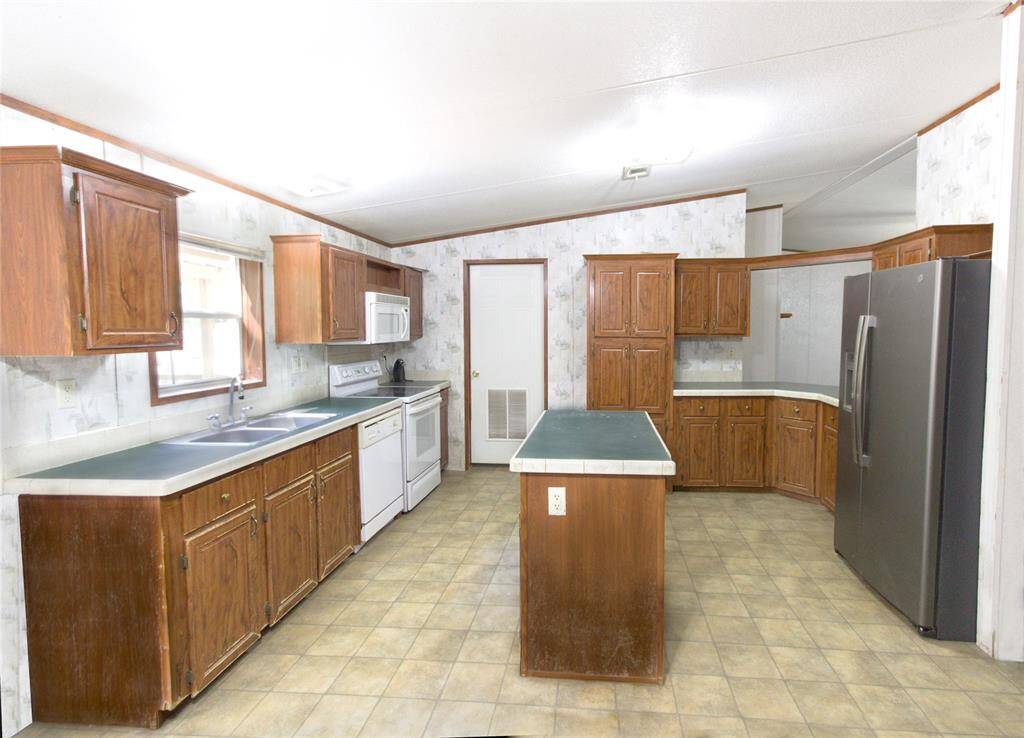 Heartwarming Kitchen/Breakfast Combo Area with a island and pass-thru counter to living area, crafted for cozy country cookin’ and lively, down-home gatherings!