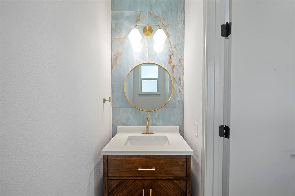 Powder room conveniently located off breakfast room and laundry room
