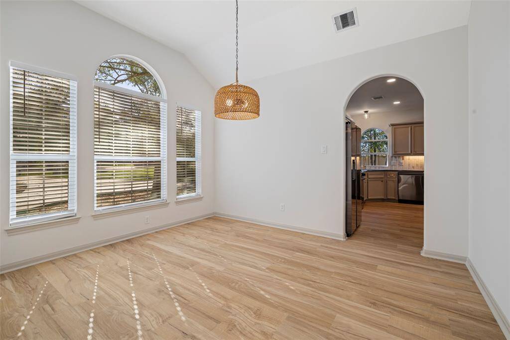 Sundrenched formal dining with entry to kitchen