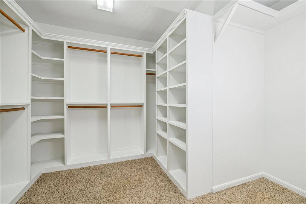 Enjoy this oversized walk-in with custom built-ins.