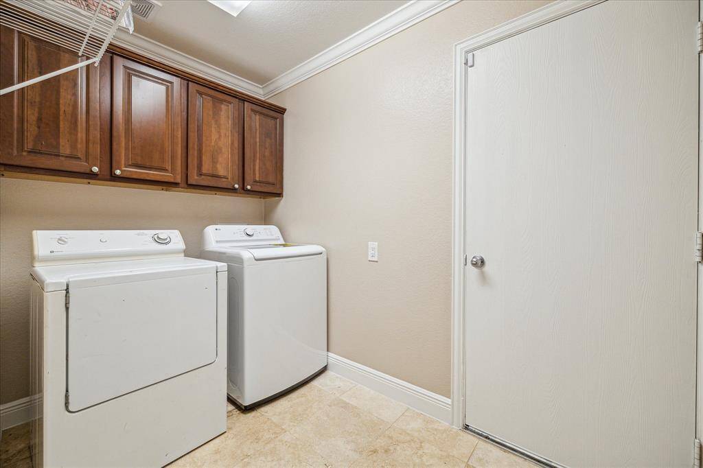 Washer & dryer included in this efficient laundry room - complete with upper cabinetry and a designated drying rack.