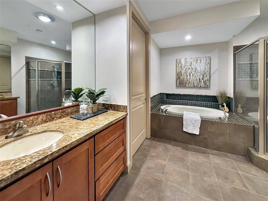 Master Bath with Jetted Tub and offers two granite topped vanities.