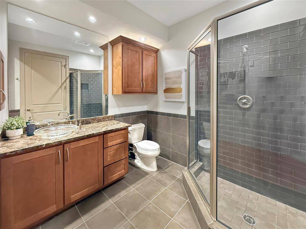 Spacious guest bath with beautiful marble counters.