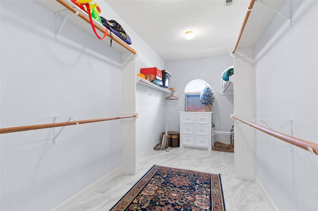 Primary closet is very spacious and features built in drawers for smart organization solutions.
