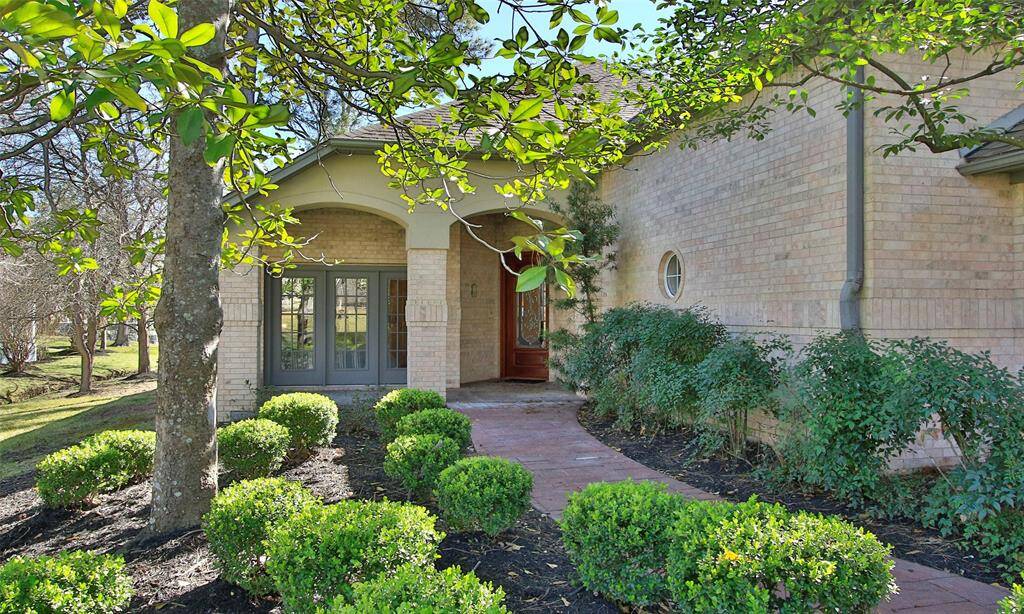 A meandering sidewalk leads to your front entry, hidden beneath shade trees at the end of a cul-de-sac.