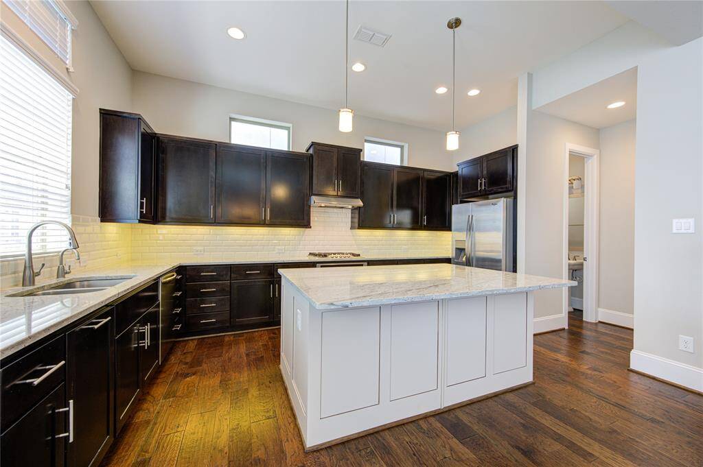 The kitchen boasts tons of cabinets, drawers and counterspace including a large island.