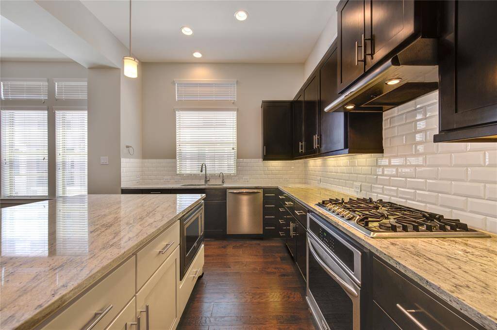 The windows provide an abundance of natural light in addition to the recessed can lights and pendants.