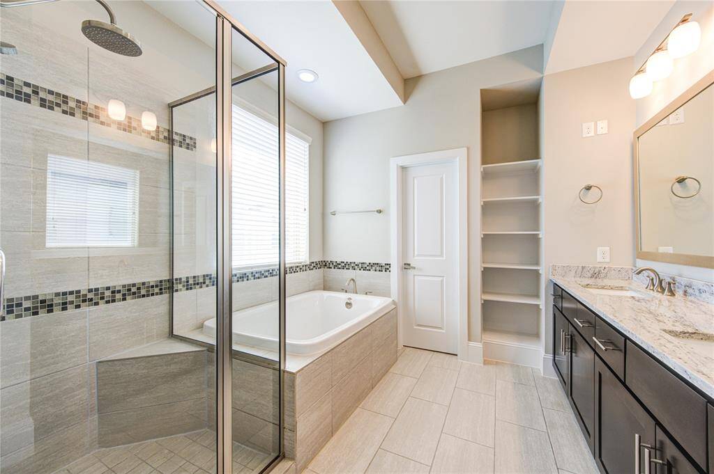 The primary features dual closets with off season racks.  There is zero carpet in this home.