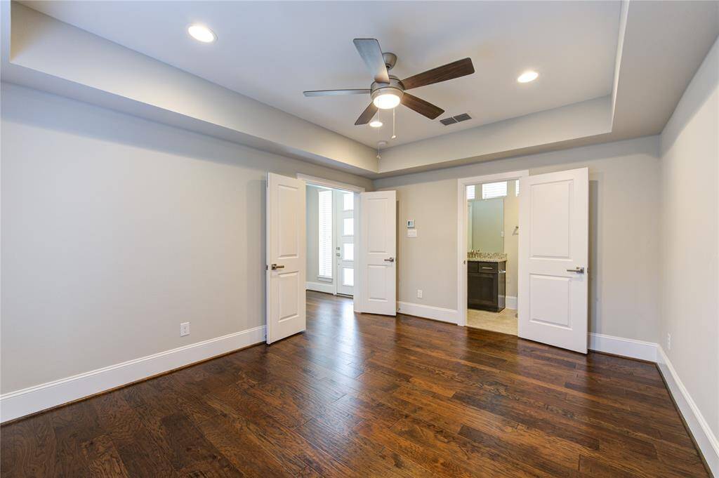 The French Doors lead to the back patio area.  The door at the rear of the photo leads to the garage.  The 2-car garage door has recently been replaced.