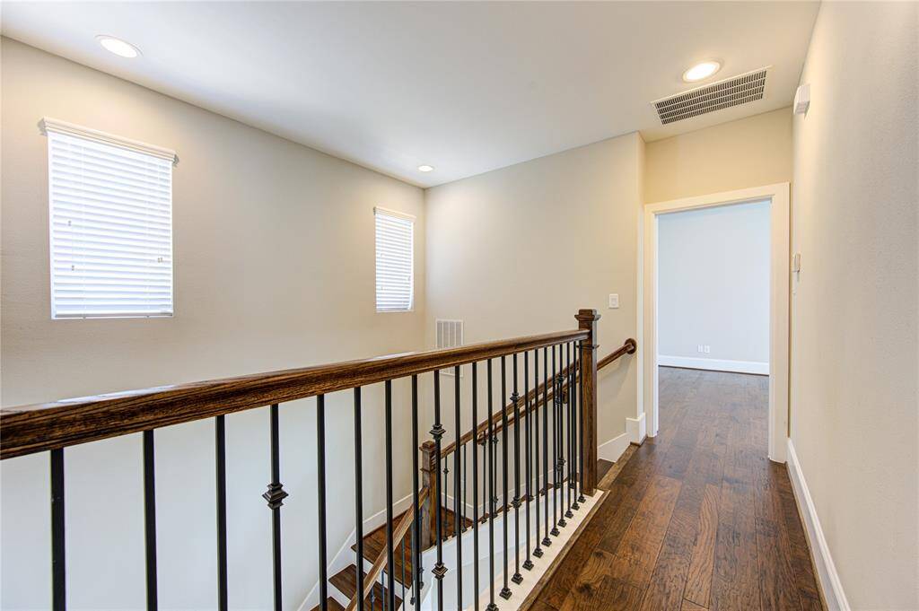 The third floor has the primary bedroom, a secondary bedroom and a smartly located utility room.