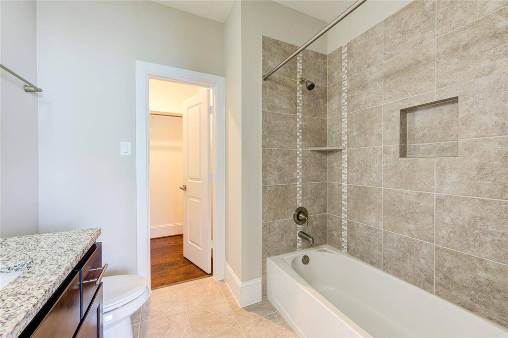 The bath ensuite features the lovely granite vanity and the tub/shower surround with mosaic inlay.