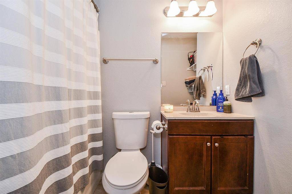 Refresh and rejuvenate in the bathroom, complete with a convenient cabinet and vanity mirror.