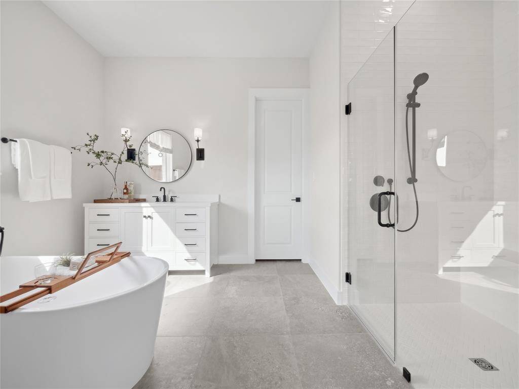 Serene primary bath with freestanding dual sinks, tub, and separate shower (*Photo not of actual home and used for illustration purposes only.)