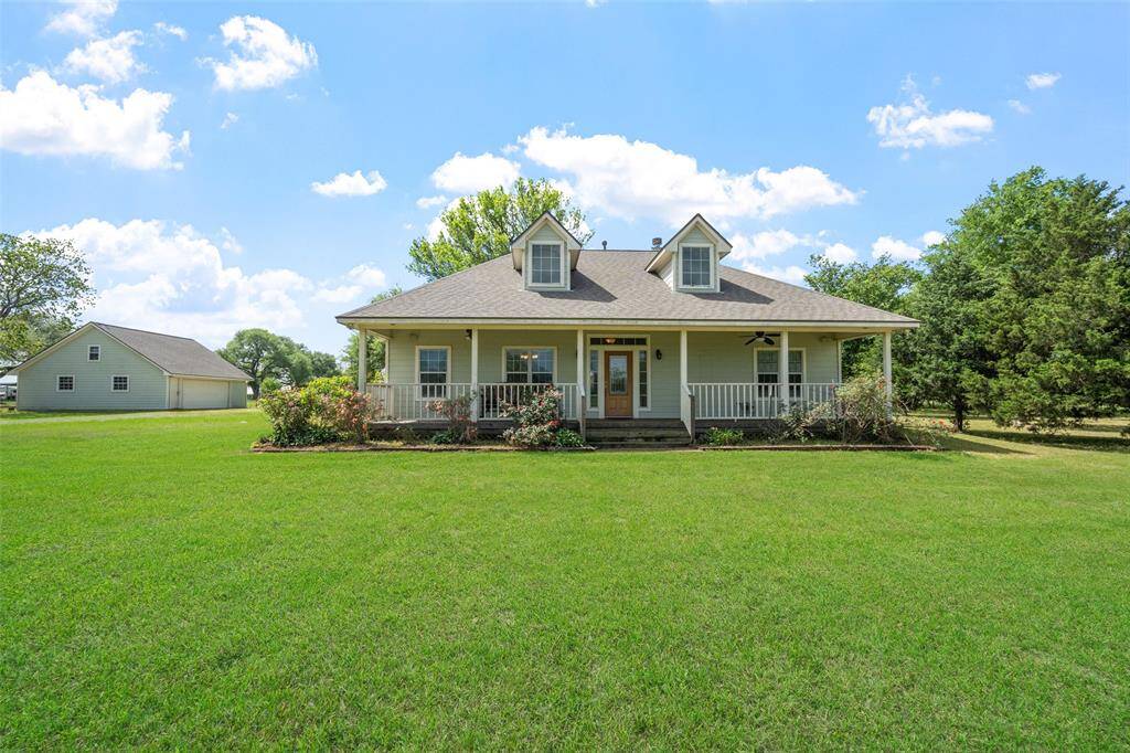 From the front, the home’s symmetrical design, dormer windows, and generous front lawn create an inviting curb appeal with timeless character.