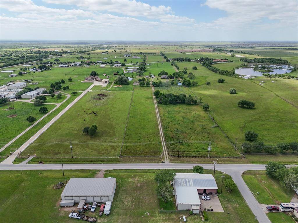 Strategically situated with peaceful surroundings, this view captures the lush landscape and neighboring water features.