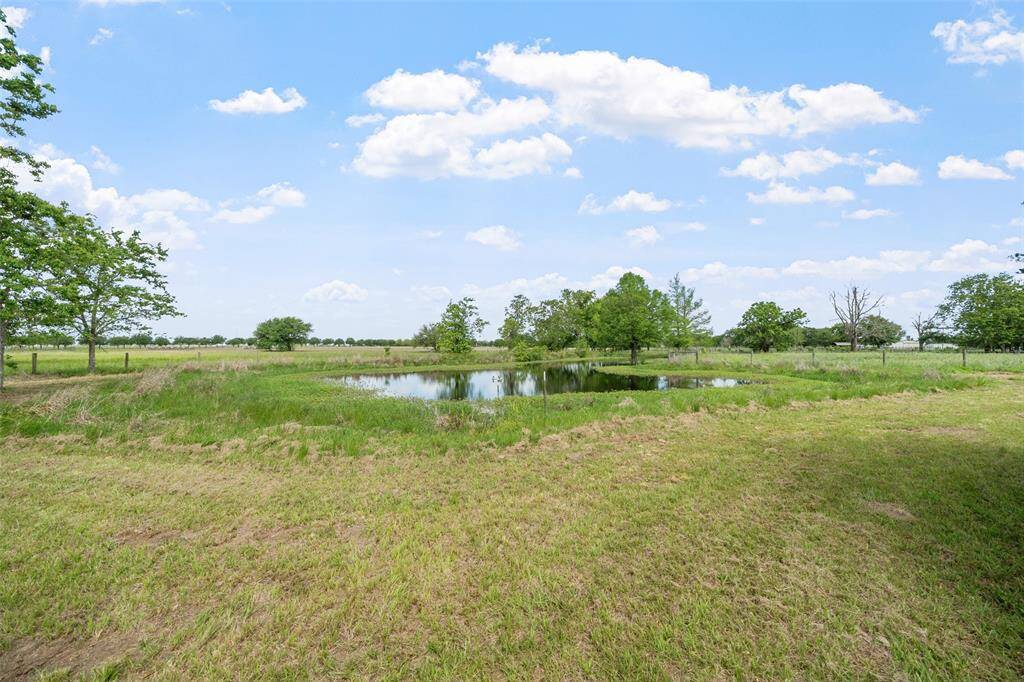 Another angle of the stocked pond emphasizes natural water sources and added value for land use or hobby farming.