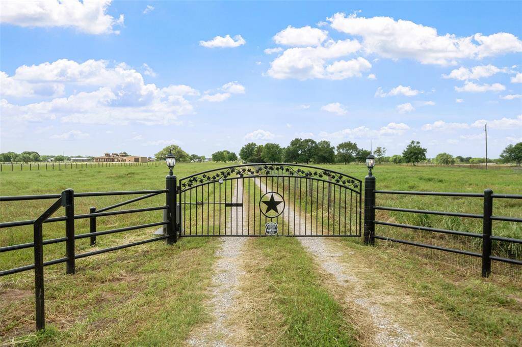 A striking gated entrance with custom star detail welcomes you home, setting the tone for this beautiful country property.