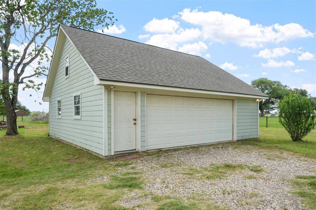 The detached two-car garage provides ample parking and extra storage, with a clean exterior that complements the home’s overall aesthetic.