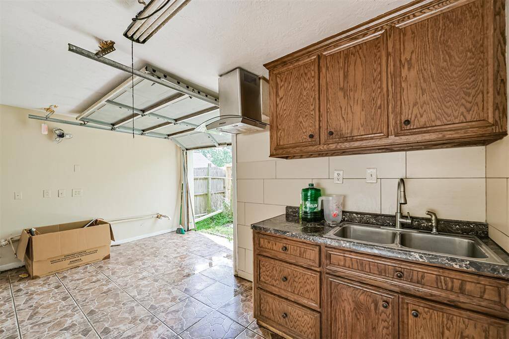 Garage Door opens to Back yard for easy yard access. Has a Kitchenette and 1/2 bath down