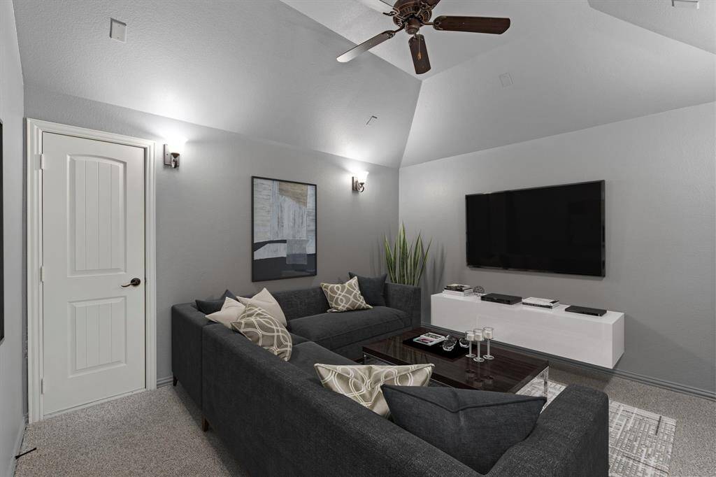 The home theater boasts high ceilings, a ceiling fan for added comfort, and elegant wall sconces for perfect lighting, creating an immersive and cozy viewing experience. *Virtually Staged*