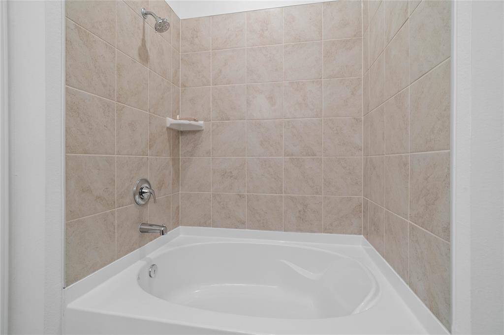 Additional view of the primary bathroom featuring the oversized tub/shower combination.