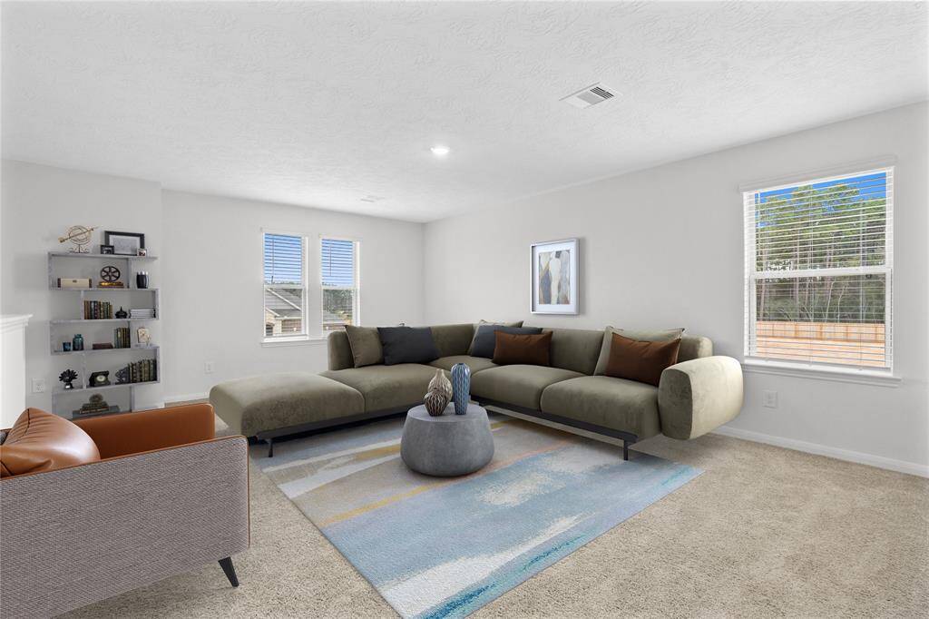 Come upstairs and enjoy a day of leisure in this fabulous game room! This is the perfect hangout spot or adult game room, this space features plush carpet, high vaulted ceiling, recessed lighting, custom paint, and plenty of windows with natural light coming in.