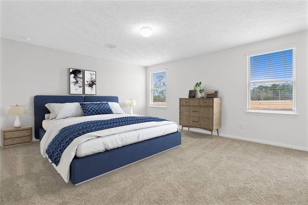Come and unwind after a long day in this magnificent primary suite! This spacious room features plush carpet, warm paint, high ceilings, and large windows with privacy blinds!