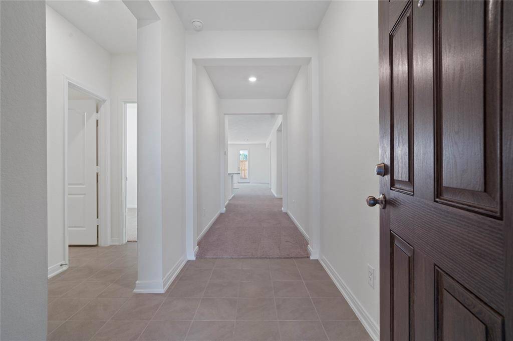 Welcome to your new home at 3535 Sage Green. You are greeted with this beautiful entryway featuring tile flooring, neutral paint, and recessed lighting.