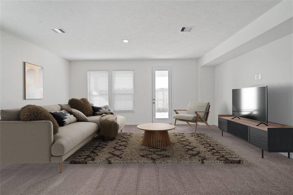 This light and bright spacious great room is the perfect layout for entertaining or just relaxing. Whether it's simply a night in or entertaining family and friends, this home has ample open space for everyone to enjoy! Featuring plush carpet flooring, large windows with blinds, high ceilings, recessed lighting with wonderful access to your gorgeous kitchen.