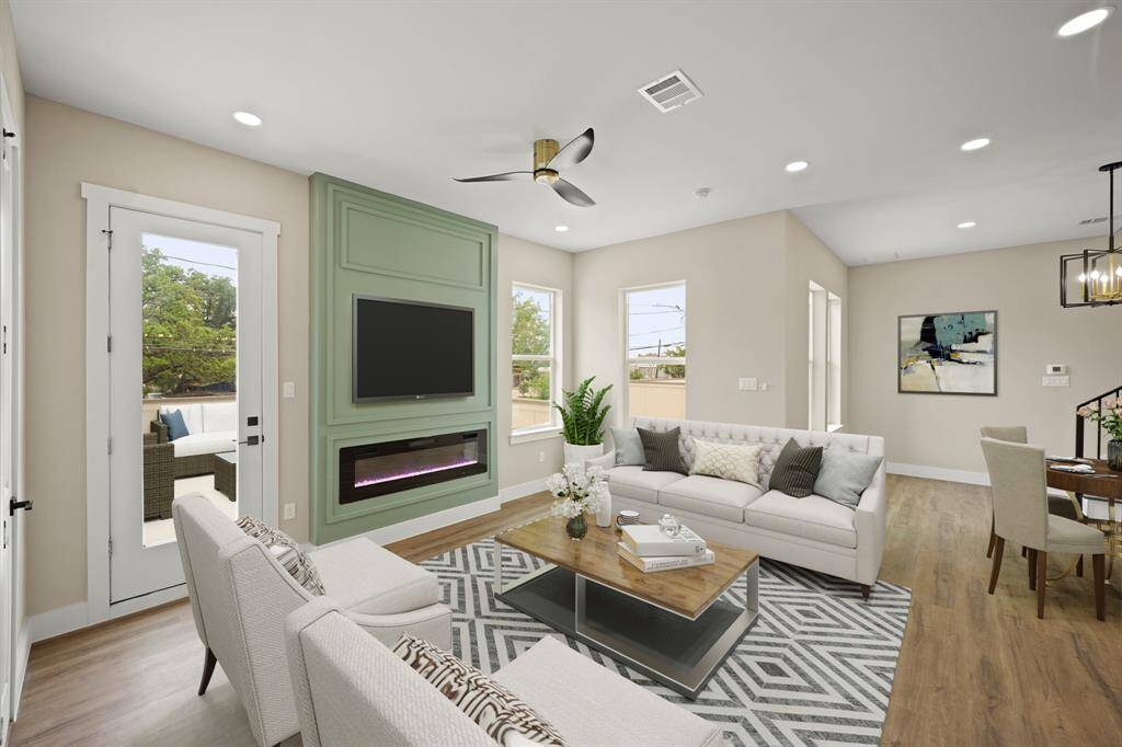 Virtually Staged: This stunning living room features new recessed lighting and vinyl plank floors, and a gorgeous electric fireplace that puts out heat.