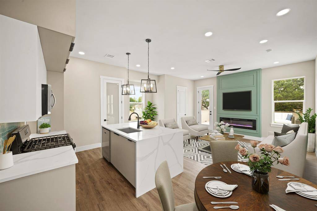 Virtually Staged: Host your next dinner party with confidence! This masterfully-equipped kitchen features a kitchen island, an abundance of new cabinetry, under cabinet lighting, quartz countertops, and stainless-steel appliances.