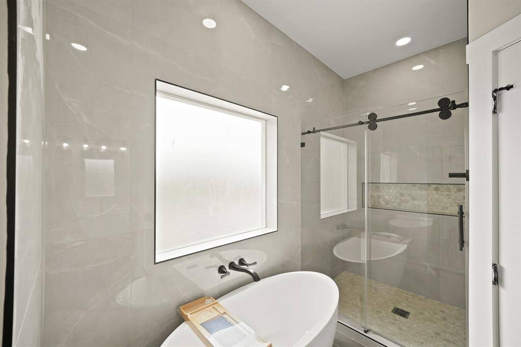 This will be your new favorite place to sit, drink a glass of wine and relax after a long day! This beautiful free standing tub has a large privacy window that lets in plenty of natural light.