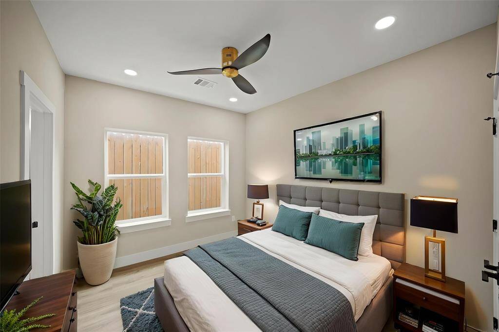Virtually Staged: Secondary bedroom with vinyl plank floors, a built-in closet, a ceiling fan, and recessed lighting.