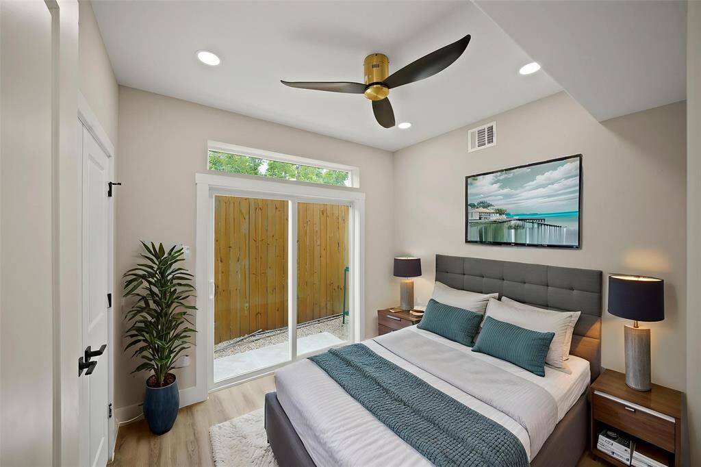 Virtually Staged: This secondary bedroom located on the first floor features recessed lighting, a ceiling fan, and vinyl plank floors.