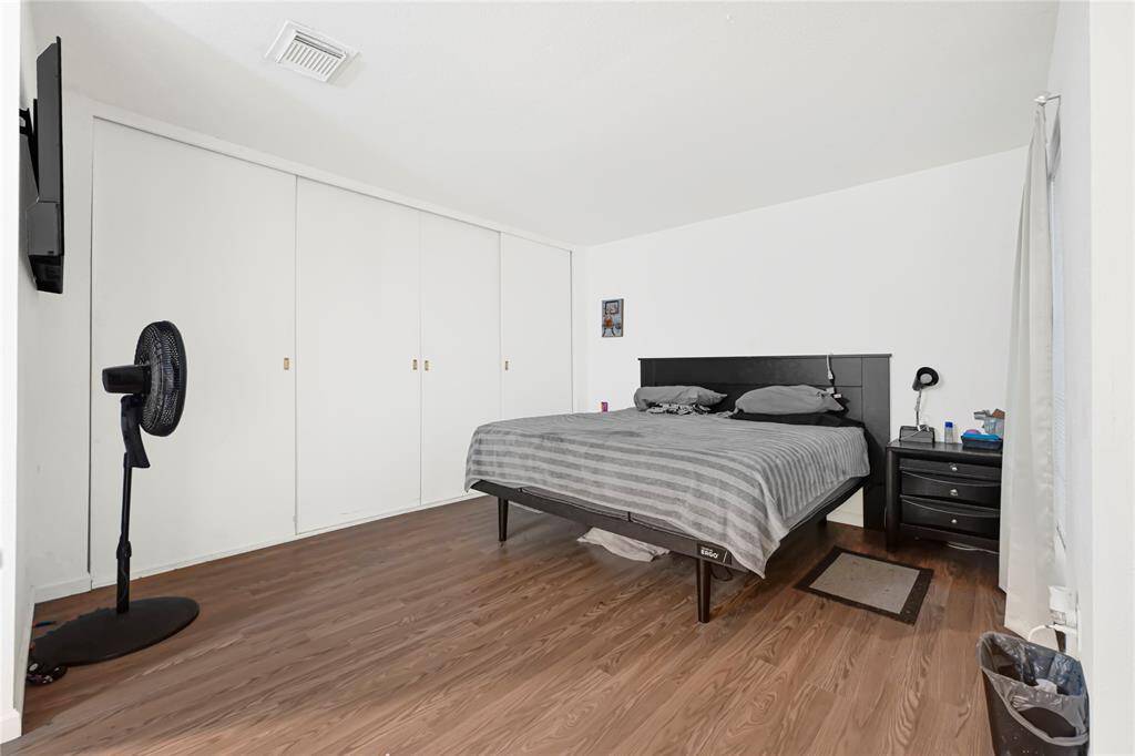 Primary bedroom offers tons of closet space, a sitting area, and your very own en-suite. There is access to the backyard through a sliding door.