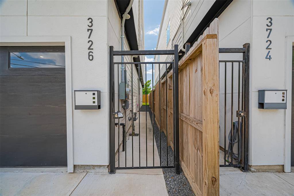 Street-facing view showcasing secure gated access, modern finishes, and elegant curb appeal.